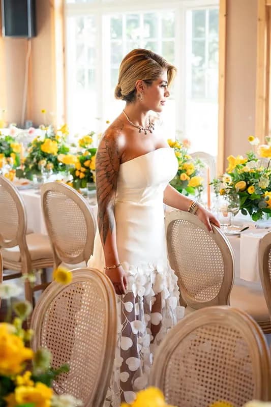 Bride at yellow floral wedding reception by Bana Florist Toronto